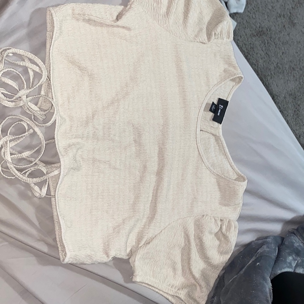 Tan crop top with open back with strings to wrap around you.